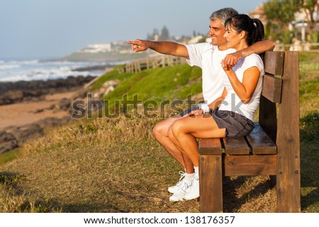 fit middle aged husband and wife at beach in the morning