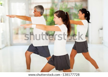 side view of healthy family exercising at home