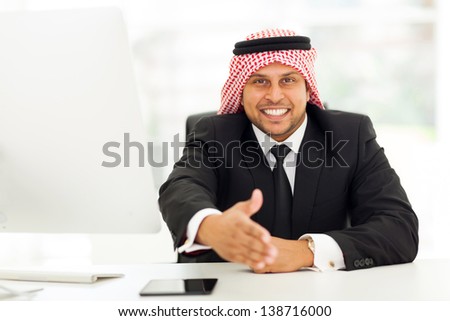 friendly arabic businessman giving handshake gesture