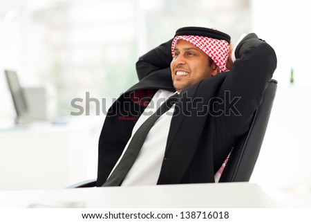 happy arab businessman relaxing in his office