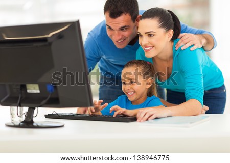 Happy Modern Family Using Computer Together At Home