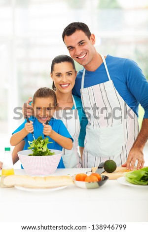 beautiful young family cooking in kitchen at home