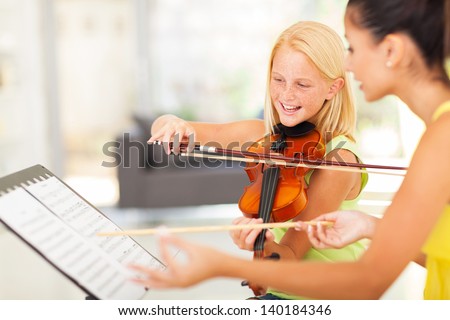 beautiful preteen girl in music class with music teacher beautiful preteen girl in music class with music teacher
