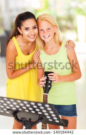 cheerful music teacher with preteen girl after music lesson