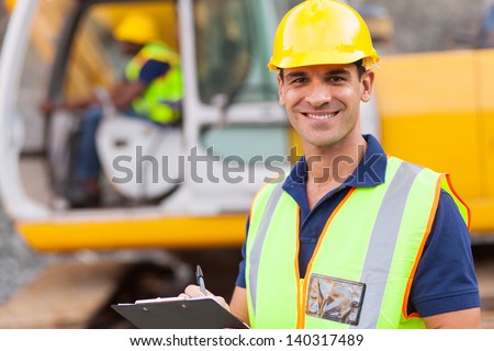 handsome road construction supervisor with clipboard