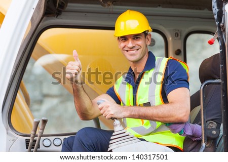 earthmover operator giving thumb up on construction site