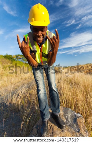 happy african construction worker outdoors