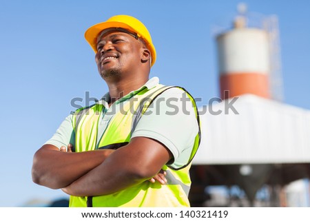 happy african male constructor with arms folded