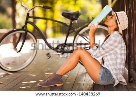pretty female university student take a break outdoors