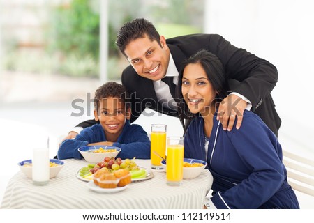 portrait of happy indian man and family before leaving for work