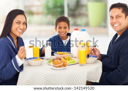 happy indian family having breakfast together at home