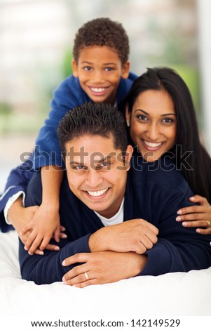 adorable indian family pyramid on bed at home