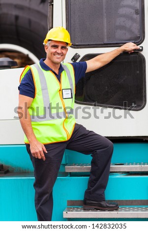 senior harbor forklift driver standing on forklift in container depot