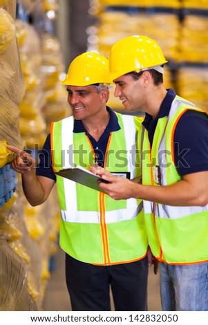 two warehouse workers doing stock take