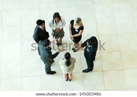 Overhead View Of People Having Business Meeting