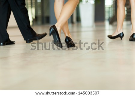 business people walking along the office