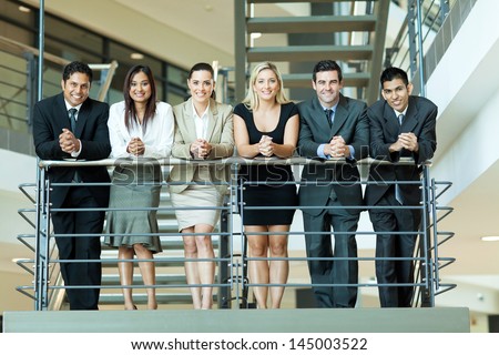 Group Of Business People Standing By Stairway
