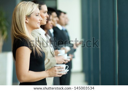 group of business people having coffee break during conference