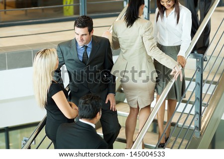 group of busy office workers walking on stairs