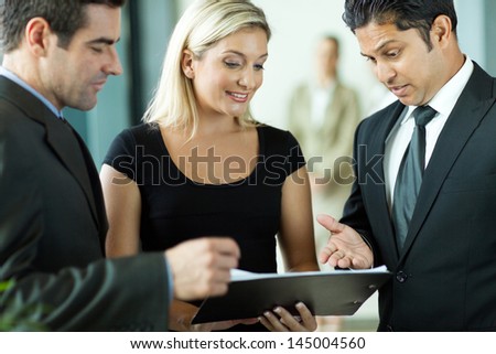business team having informal meeting discussing a contract