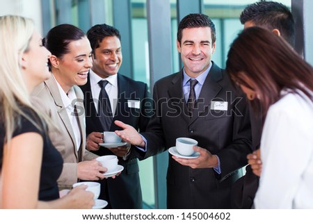 funny businessman telling a joke during conference coffee break