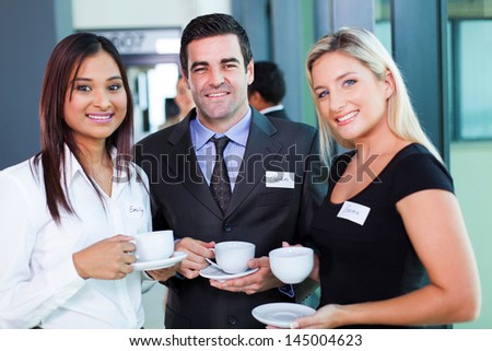 group of business people having coffee during business conference break