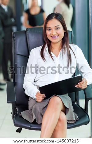 beautiful indian corporate worker sitting in office