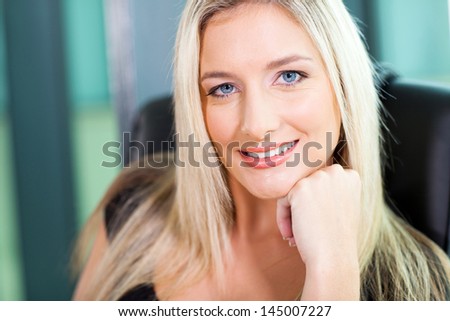 pretty smiling businesswoman closeup portrait in office