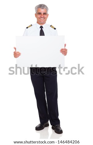 smiling senior airline pilot captain holding white board on white background
