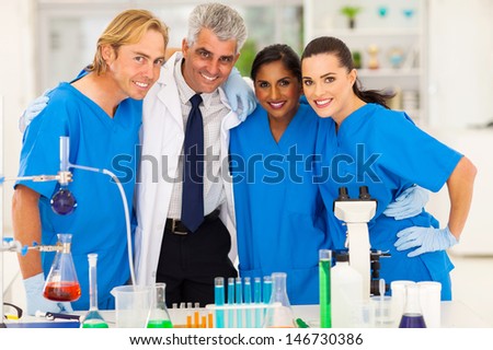 group of smiling scientists team in laboratory
