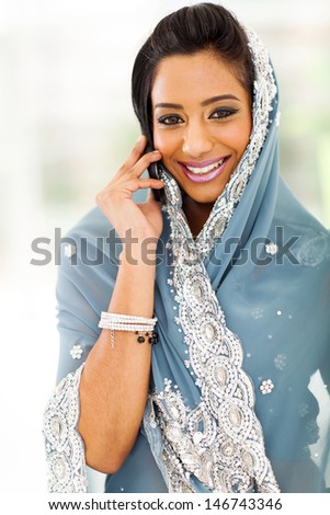 beautiful young Indian woman in traditional clothing talking on cellphone