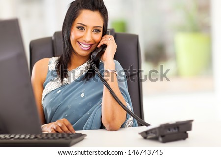 Attractive Young Indian Receptionist Talking On The Phone