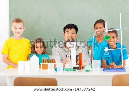 group elementary school students and teacher in a science class