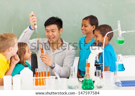 primary school science teacher demonstrating science experiment