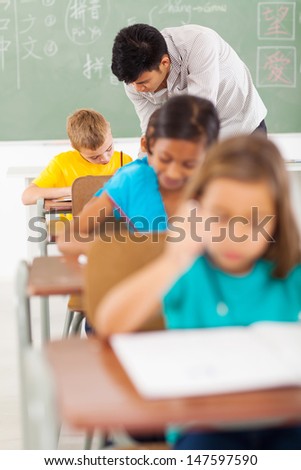 chinese language teacher and students in classroom during lesson