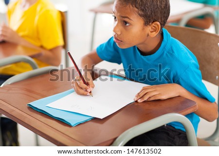 adorable african american primary school student studying Chinese in classroom