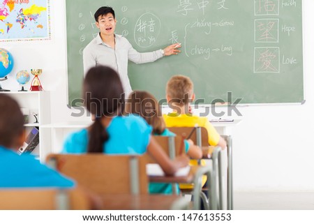 elementary school teacher teaching chinese language in classroom
