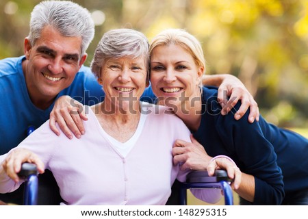 Portrait Of Mid Age Couple And Senior Mother Outdoors