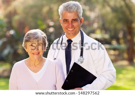 happy middle aged doctor and senior patient outdoors