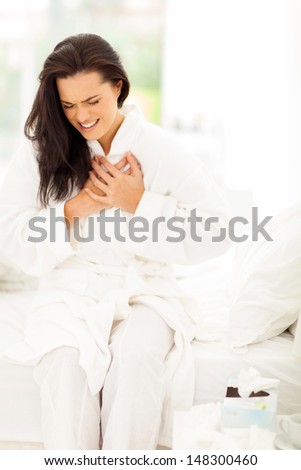 young woman in pajamas having heart attack
