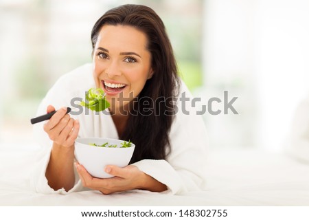 beautiful vegetarian eating fresh green salad at home