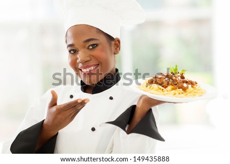 beautiful afro american chef presenting spaghetti
