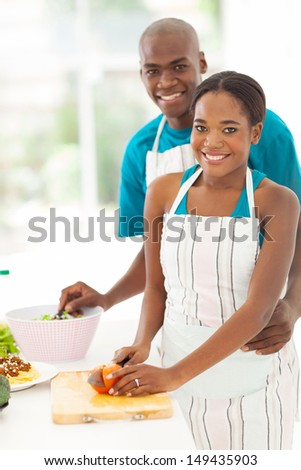 cute african american couple cooking healthy food together