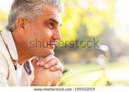 portrait of thoughtful middle aged man outdoors