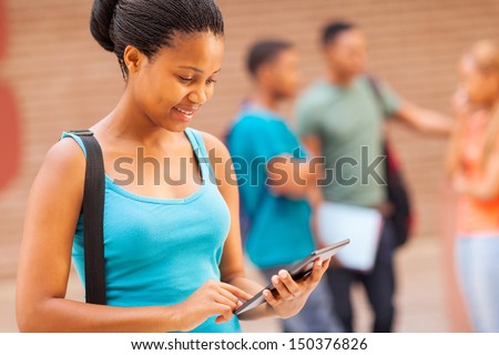 beautiful female african college student with tablet computer on campus