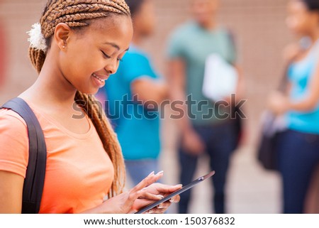 young african college student using tablet computer searching for information