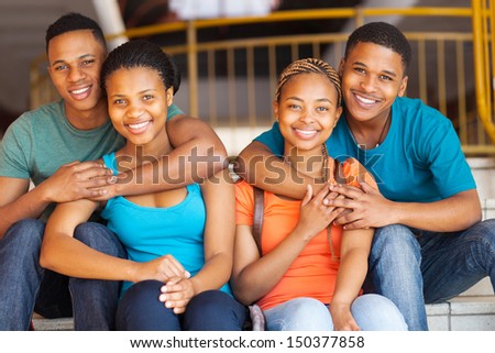group of african american university friends sitting on stairs