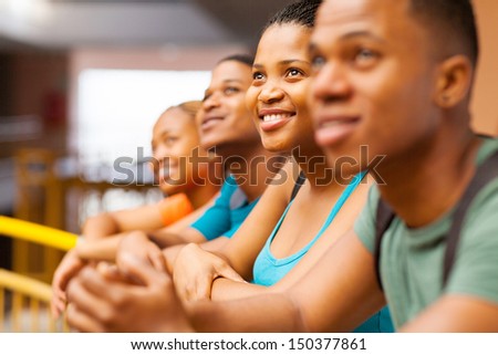 group of happy african college students looking up