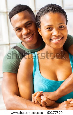 happy african college couple hugging