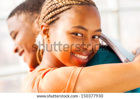 beautiful young african girl hugging her boyfriend